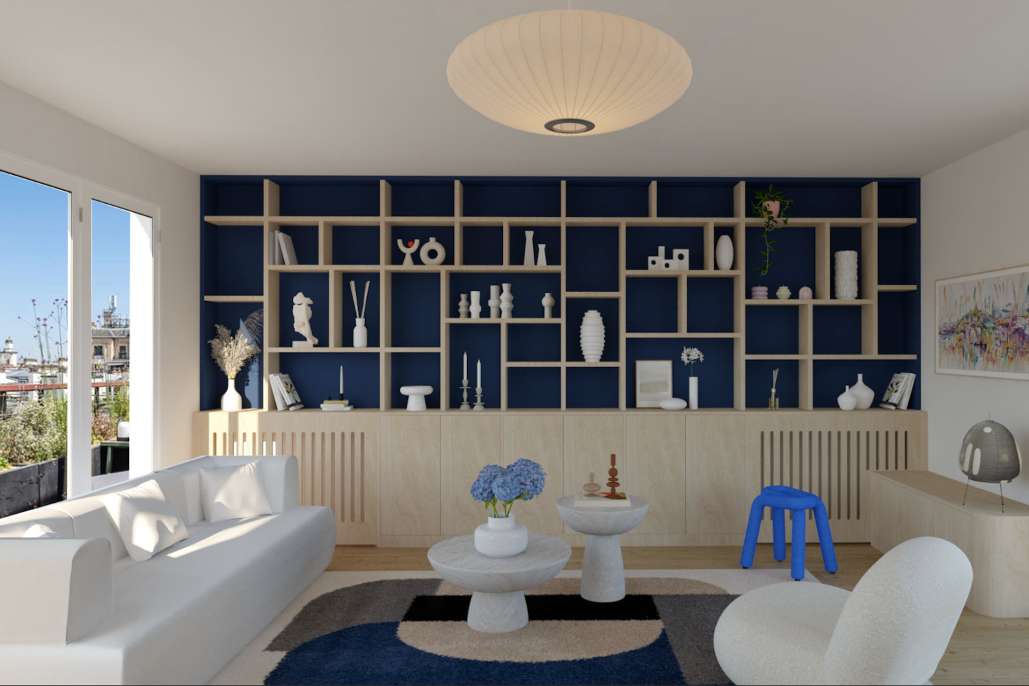 Bibliothèque sur mesure conçue par l’architecte d’intérieur ELLESTUDIO à Paris : design fonctionnel, optimisation de l’espace, bois clair chaleureux et fond bleu foncé pour un contraste élégant.