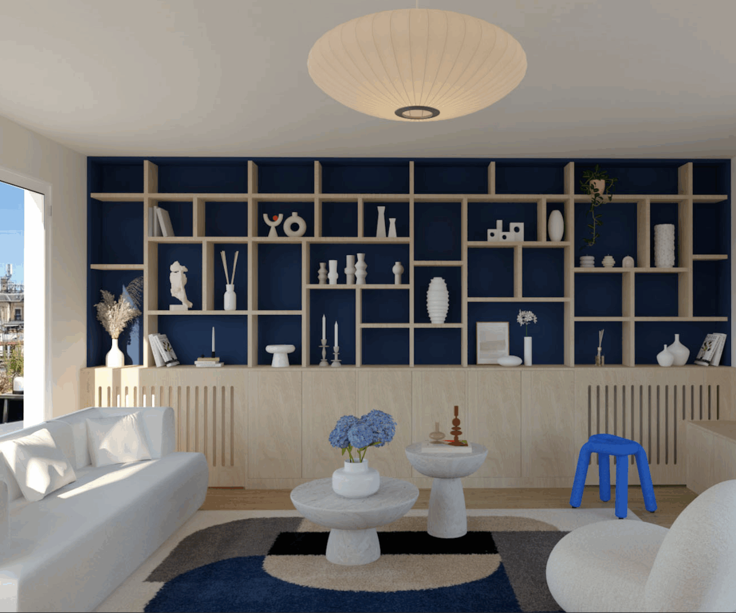 Bibliothèque sur mesure conçue par l’architecte d’intérieur ELLESTUDIO à Paris : design fonctionnel, optimisation de l’espace, bois clair chaleureux et fond bleu foncé pour un contraste élégant.